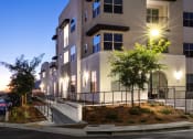 Thumbnail 1 of 26 - an image of a building at night with lights on it at Luma at El Corazon Apartments, Oceanside, CA 92056