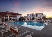 Thumbnail 3 of 26 - a swimming pool at dusk at Luma at El Corazon Apartments, Oceanside, California