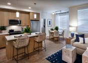 Thumbnail 10 of 26 - a living room and kitchen with a couch and a table at Luma at El Corazon Apartments, Oceanside