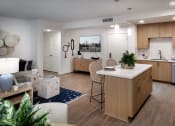 Thumbnail 11 of 26 - a kitchen and living room in an apartment at Luma at El Corazon Apartments, Oceanside
