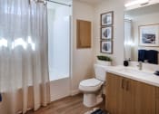 Thumbnail 23 of 26 - a bathroom with a shower and a toilet and a sink at Luma at El Corazon Apartments, Oceanside