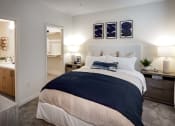 Thumbnail 20 of 26 - a bedroom with a bed and a bathroom at Luma at El Corazon Apartments, California 92056
