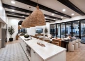 Thumbnail 14 of 26 - the kitchen is open to the living room and dining room at Luma at El Corazon Apartments, Oceanside, CA