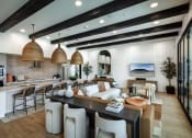 Thumbnail 15 of 26 - a large living room with a kitchen and a dining room at Luma at El Corazon Apartments, California 92056