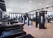 Thumbnail 26 of 26 - a symmetrical view of a large room with rows of machines at Luma at El Corazon Apartments, California