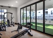 Thumbnail 24 of 26 - a home gym with exercise equipment and glass windows at Luma at El Corazon Apartments, Oceanside, 92056