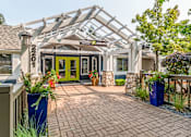 Thumbnail 13 of 20 - the front entrance of a house with a walkway and a greenhouse