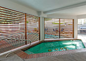Thumbnail 2 of 20 - a spa with a pool and sliding glass doors