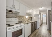 Thumbnail 4 of 33 - Kitchen With White Appliances at Carriage Hill, Colorado, 80260