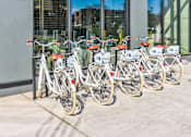 Thumbnail 15 of 19 - A row of bicycles are parked in front of a building.