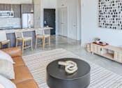 Thumbnail 11 of 19 - A modern kitchen with a black table in the middle.