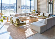 Thumbnail 8 of 19 - A living room with a couch, chair, and table.