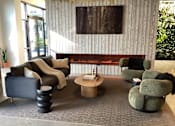 Thumbnail 2 of 19 - A living room with a grey carpet and a wooden wall.