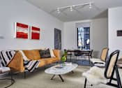 Thumbnail 22 of 113 - a living room with a couch and chairs and a dining room table at The Audubon New Haven, New Haven, CT, 06511