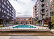 Thumbnail 56 of 113 - a swimming pool in between two tall buildings at The Audubon New Haven, Connecticut, 06511