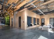 Thumbnail 8 of 113 - a large living room with large windows and a concrete floor at The Audubon New Haven, New Haven, CT