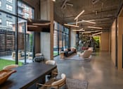 Thumbnail 21 of 113 - the interior of a large office space with furniture and large windows at The Audubon New Haven, New Haven, Connecticut