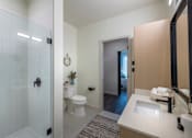 Thumbnail 29 of 113 - a bathroom with a shower toilet and sink at The Audubon New Haven, New Haven