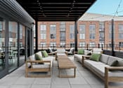Thumbnail 11 of 113 - a communal patio with couches and tables on a rooftop at The Audubon New Haven, New Haven, CT, 06511