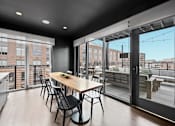 Thumbnail 6 of 113 - a dining area with a wooden table and chairs and a large window with a balcony at The Audubon New Haven, New Haven, Connecticut