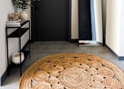 Thumbnail 9 of 10 - A black door is in a room with a round rug in front of it.
