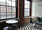 Thumbnail 6 of 10 - a small room with a table and chairs and a window