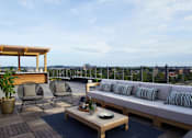 Thumbnail 107 of 113 - a rendering of a balcony with a couch and chairs at The Audubon New Haven, Connecticut
