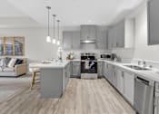 Thumbnail 1 of 24 - A modern kitchen with a large island and stainless steel appliances.