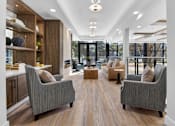 Thumbnail 12 of 24 - A modern living room with grey couches and wooden floors.