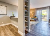 Thumbnail 1 of 38 - an open living room with a book shelf and a sliding glass door