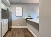 Thumbnail 22 of 38 - an empty kitchen with white cabinets and a stainless steel refrigerator
