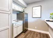 Thumbnail 21 of 38 - a kitchen with white cabinets and a stainless steel refrigerator