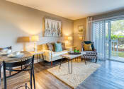 Thumbnail 2 of 38 - a living room with a couch and a table and a sliding glass door