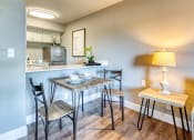Thumbnail 19 of 38 - a dining area with a table and chairs and a kitchen