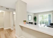 Thumbnail 9 of 38 - a living room with a long counter and a large window