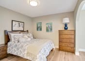Thumbnail 23 of 38 - a bedroom with a bed and a dresser