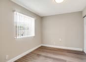 Thumbnail 7 of 38 - the spacious living room with a large window and wood flooring