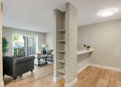 Thumbnail 10 of 38 - a living room with a couch and a bookshelf