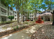 Thumbnail 33 of 38 - a courtyard with a fountain in front of an apartment building