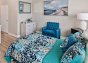Thumbnail 7 of 16 - Bedroom with a blue floral bedspread at Azure Point at Encinitas - 55+ Active Adult Apartments, Encinitas