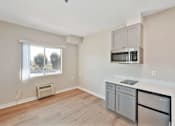 Thumbnail 22 of 25 - A kitchen with a stainless steel dishwasher and microwave.