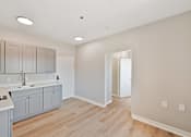 Thumbnail 20 of 25 - A kitchen with grey cabinets and a white counter top.