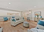 Thumbnail 13 of 25 - A living room with a white couch and blue pillows.
