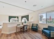 Thumbnail 10 of 25 - A room with a reception desk and chairs.