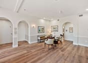 Thumbnail 7 of 25 - A room with arched doorways and a wooden floor.