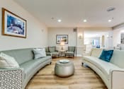 Thumbnail 4 of 16 - Living room with a grey couch at Azure Point at Encinitas - 55+ Active Adult Apartments, Encinitas, California