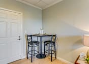 Thumbnail 10 of 10 - A small dining room with a table and two chairs.