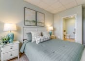 Thumbnail 7 of 10 - A bedroom with a large bed and two lamps.