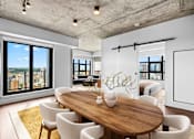 Thumbnail 6 of 12 - Suite 2502 - A modern dining room with a wooden table and chairs.