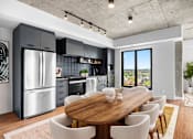 Thumbnail 8 of 12 - Suite 2502 - A modern kitchen with a wooden dining table and chairs.